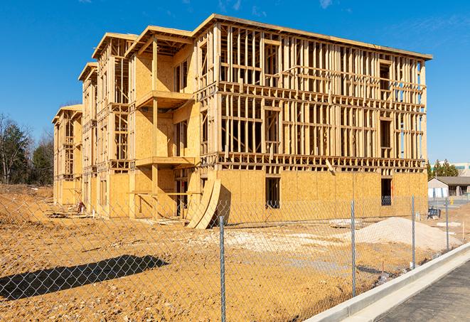 construction zone secured with a temporary fence, marked with warning signs in Lenexa, KS